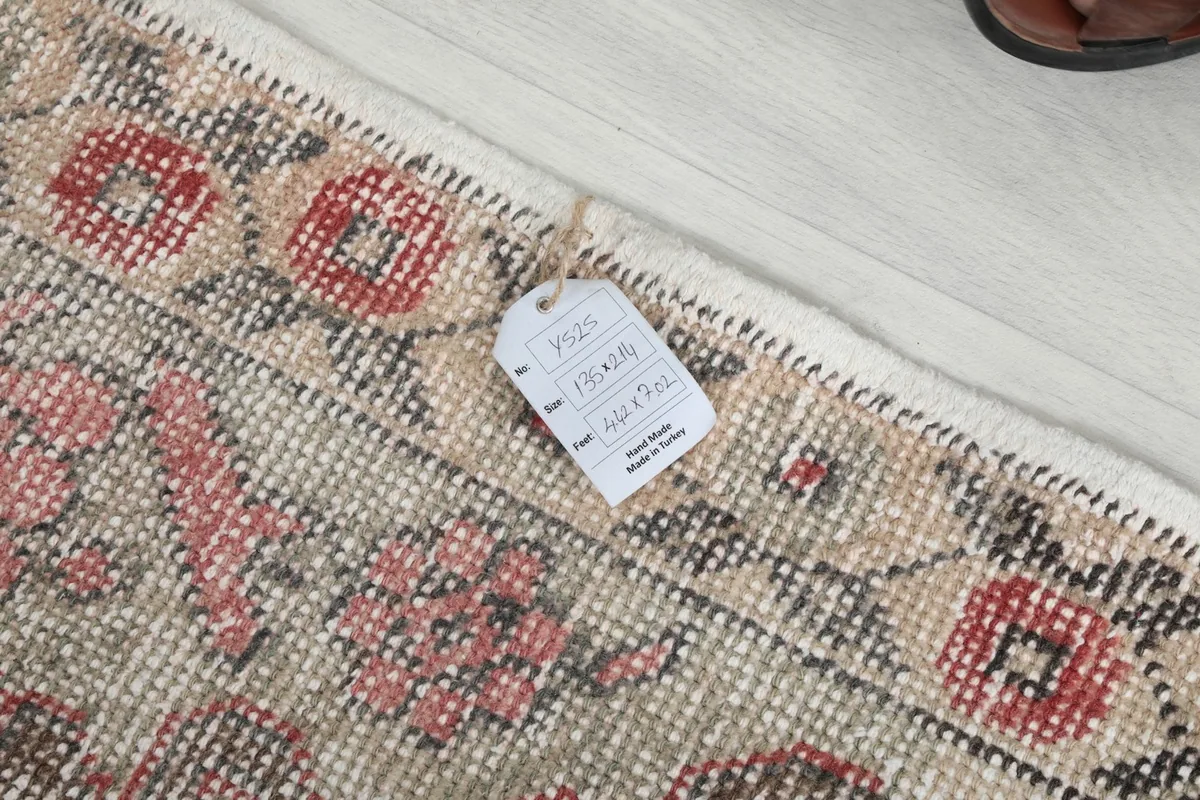 Close-up of the rug's edge with a product tag showing dimensions and origin.