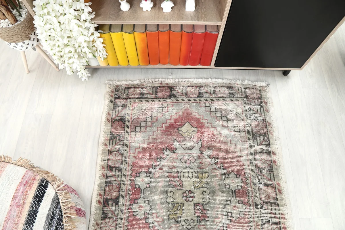 Direct overhead view of the vintage Anatolian rug, capturing its symmetrical geometric design and border.