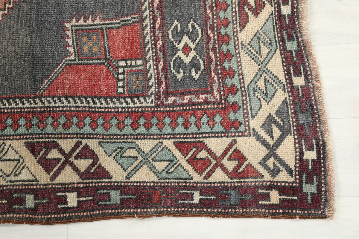 Close-up of the geometric border design of the Red Gray Tribal Medallion Rug