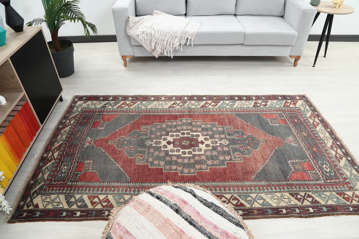 Red Gray Tribal Medallion Rug laid out in a room, showcasing its medium size and design