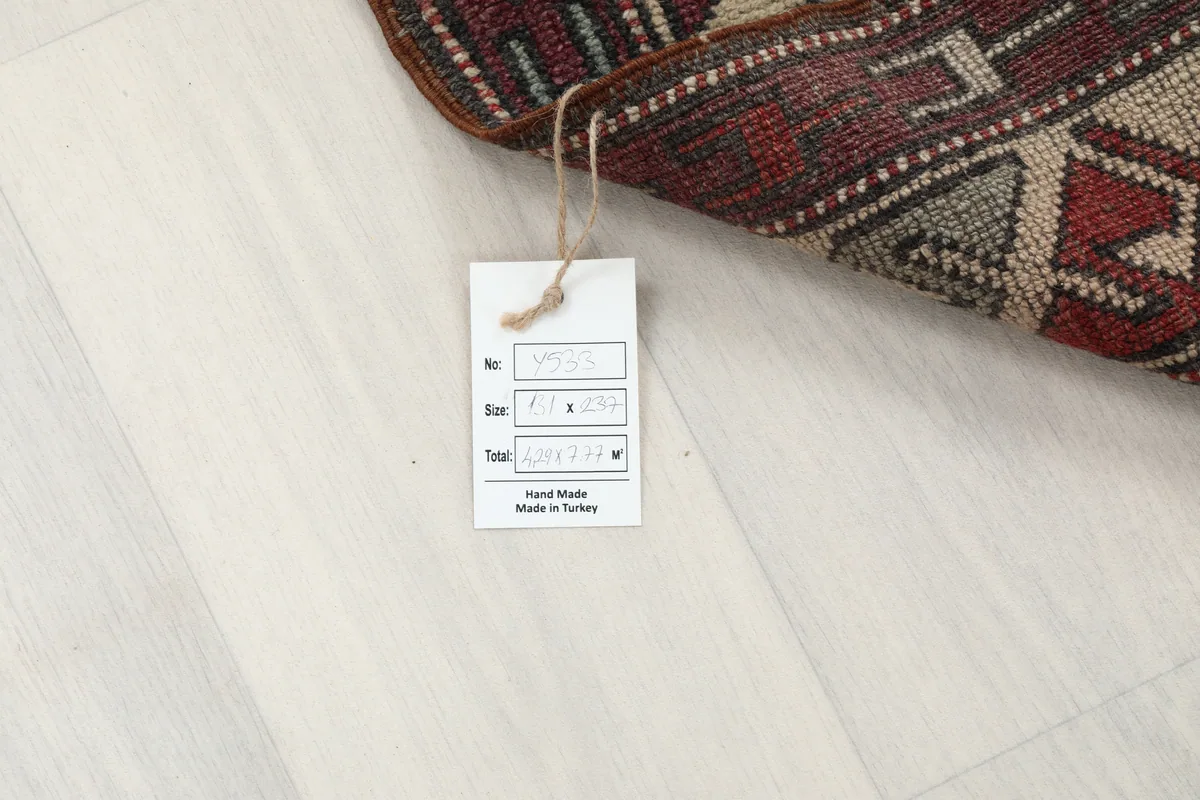 Tag on the Red Gray Tribal Medallion Rug confirming its size and origin