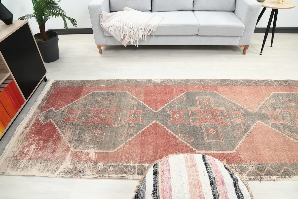 Runner rug stretching down a hallway-like space, providing a sense of its scale in a home environment.