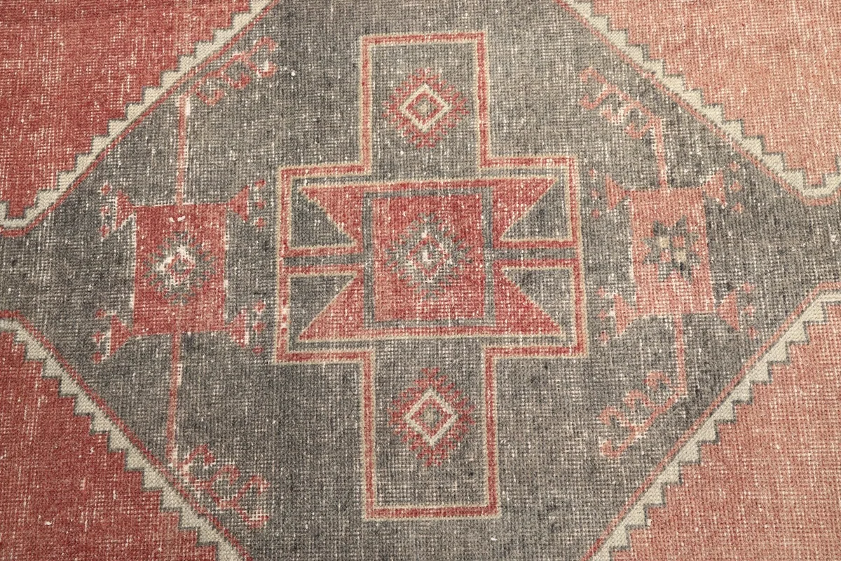Close-up of a main geometric medallion, revealing the intricate patterns and color variations.