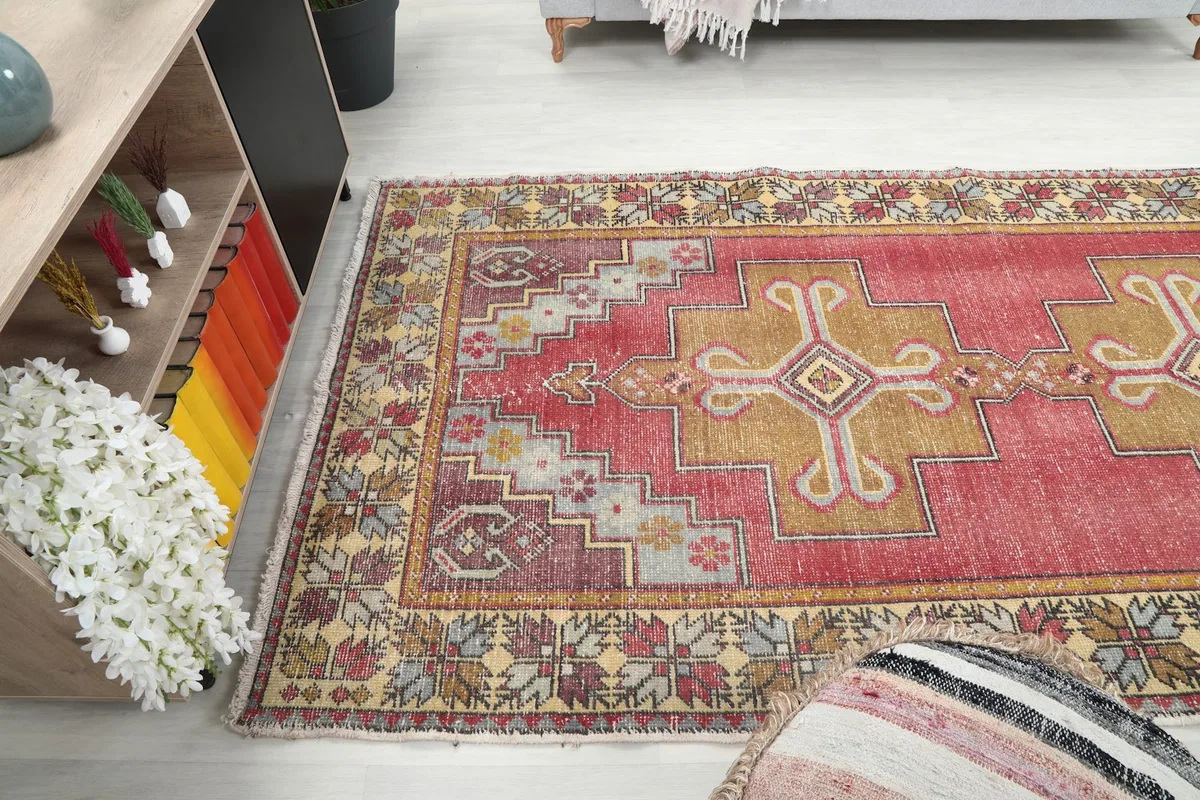 Angled shot of the rug from the side, showcasing its length and vibrant border