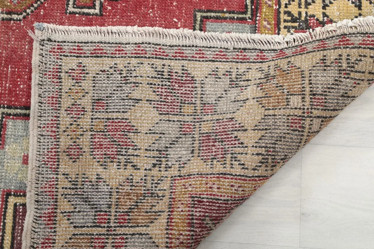 Close-up of the rug's back, showing the consistent hand-knotted weave and fringe