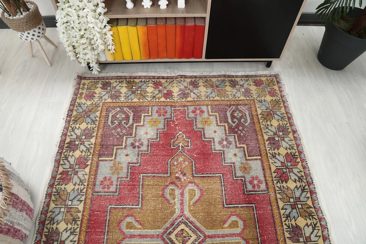 Overhead view of the vintage rug, showing the upper half and surrounding room elements