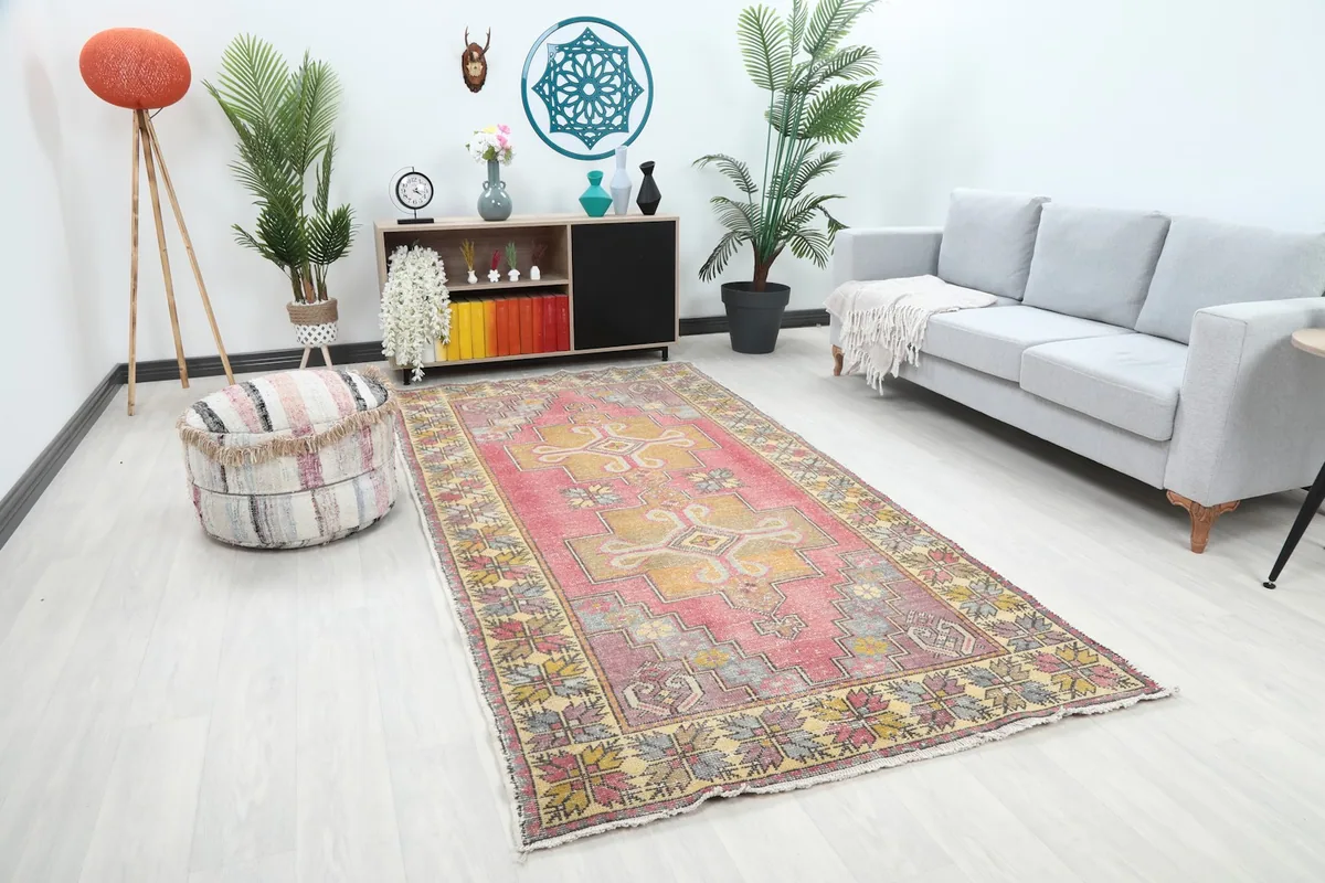 Angle view of the rose and gold rug in a modern living space, showing its full length