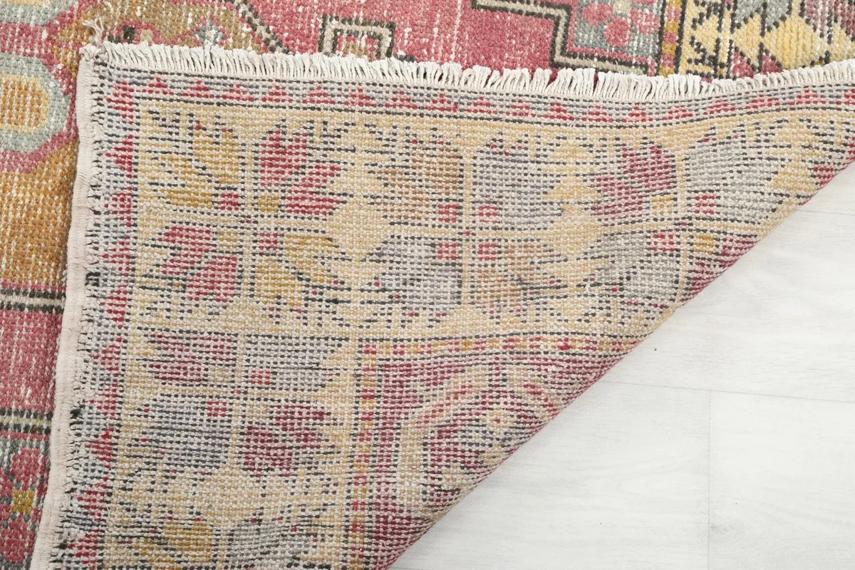 View of the rug's reverse side, showing the dense hand-knotted construction