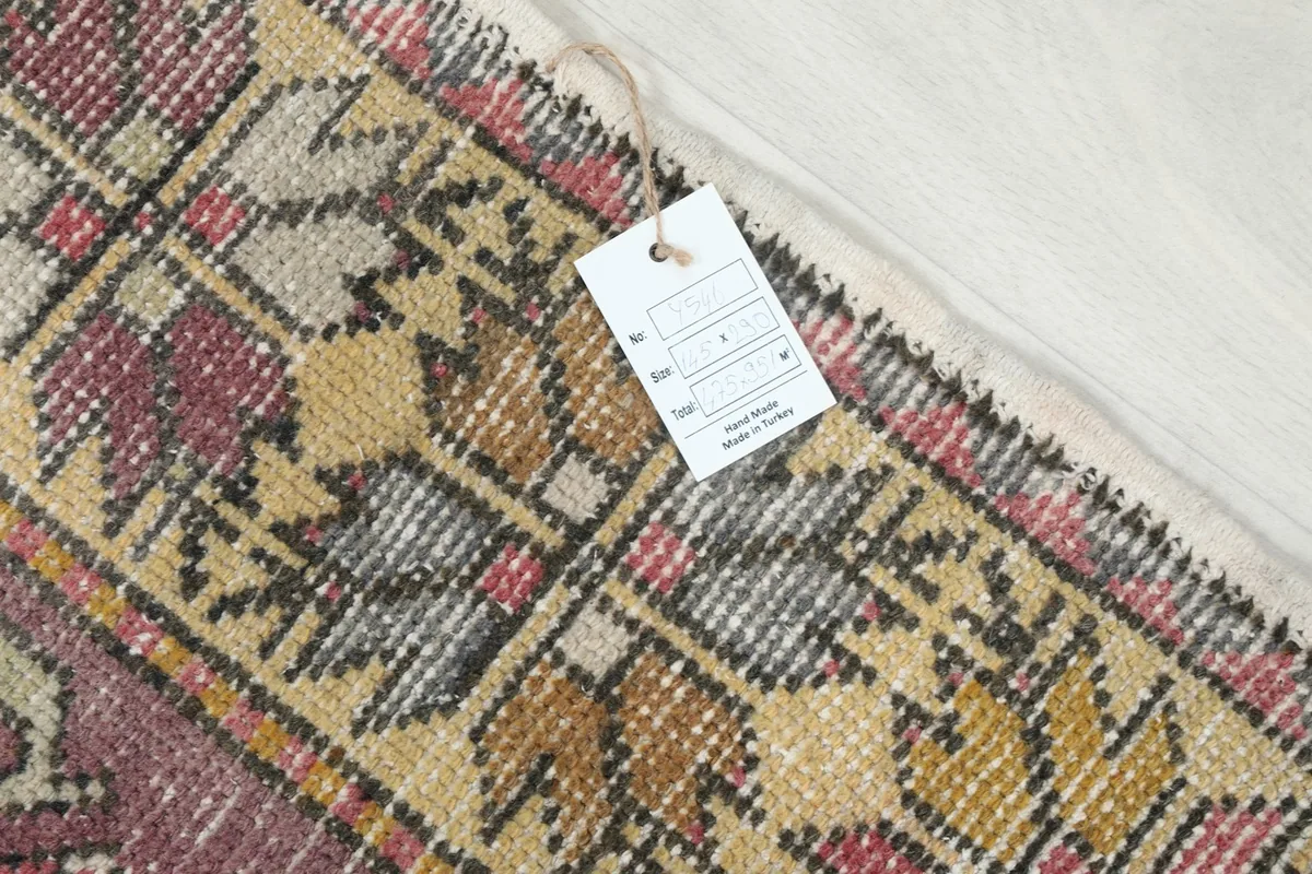 Close-up of the rug's edge with a product tag, displaying the quality and origin