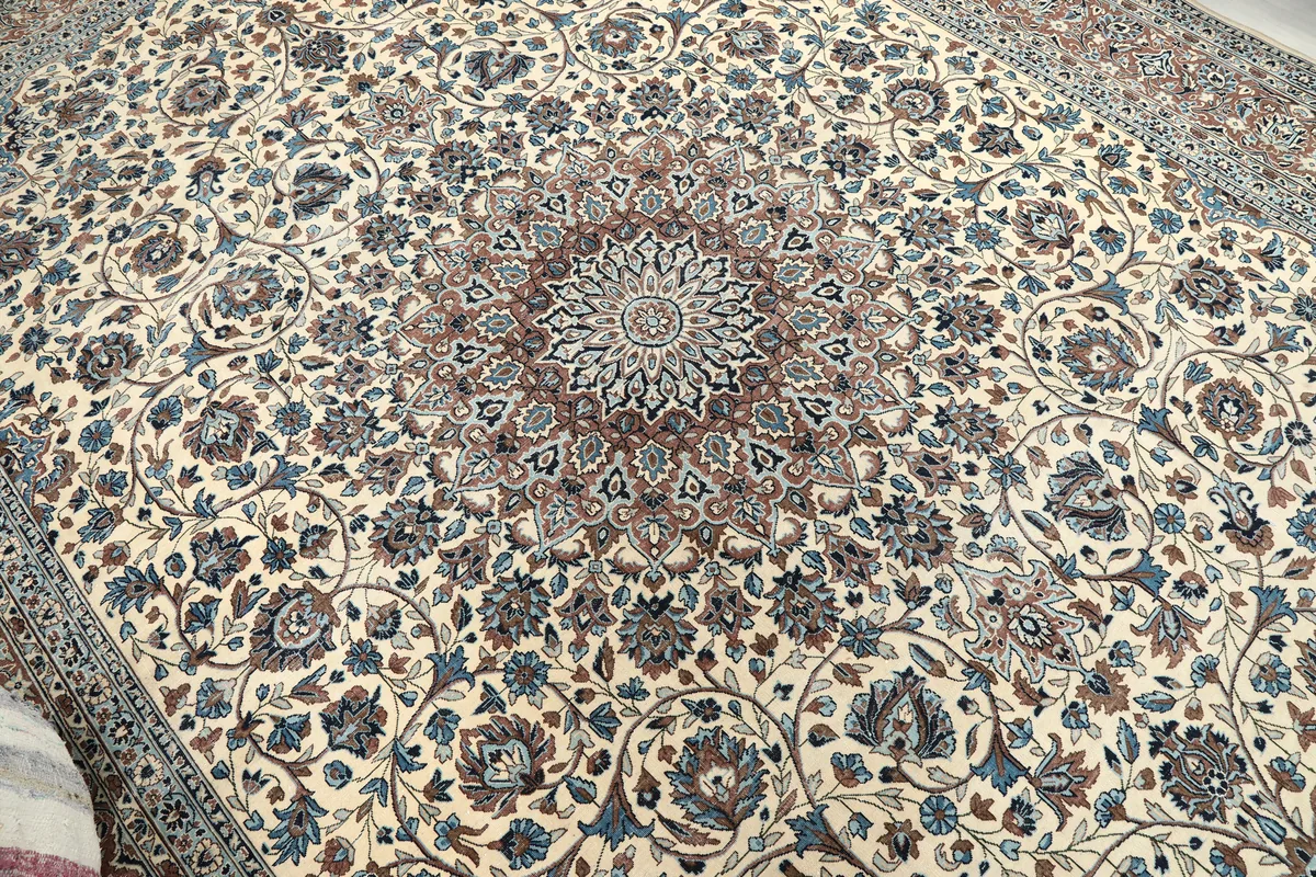 Close-up view of the central medallion and surrounding floral patterns on the Ivory Floral Medallion Anatolian Rug