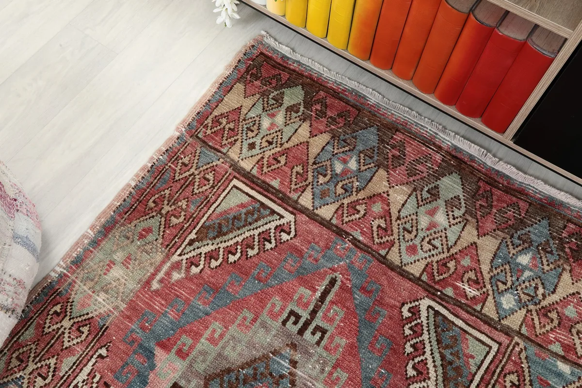 Top-down view of one end of the runner, showing its colors and motifs near furniture