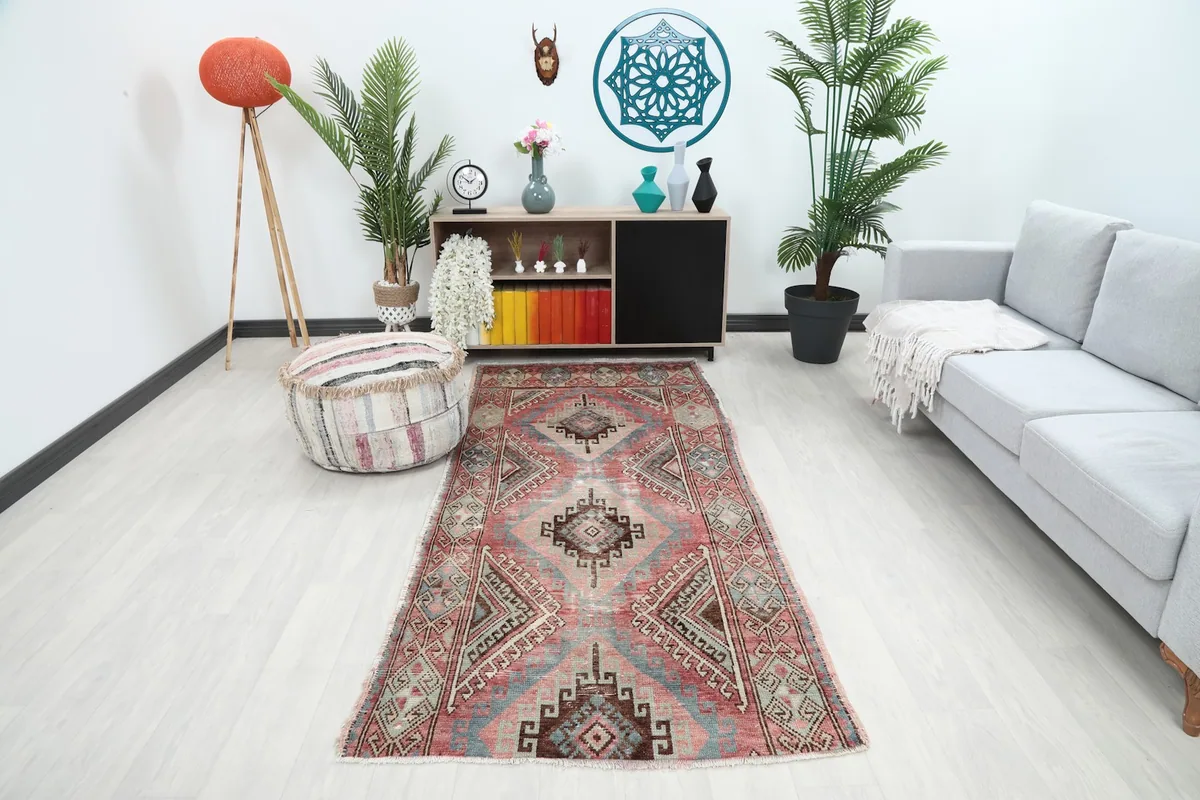 Vintage rose and blue runner rug displayed in a living room setting