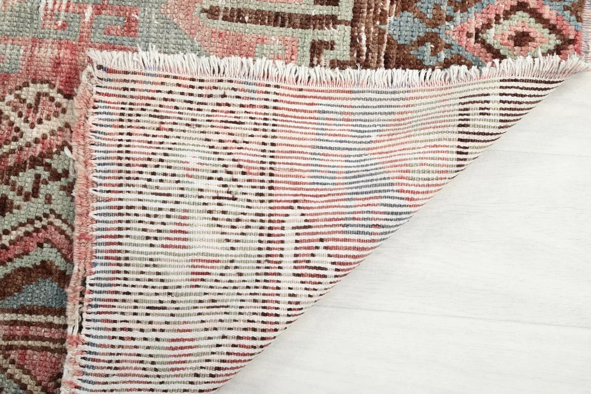 Underside view of the hand-knotted wool pile on cotton foundation of the rug