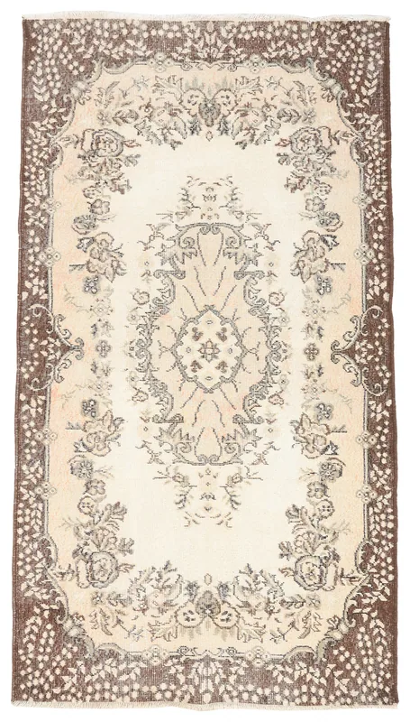 Full top view of the ivory and brown floral medallion vintage Anatolian rug