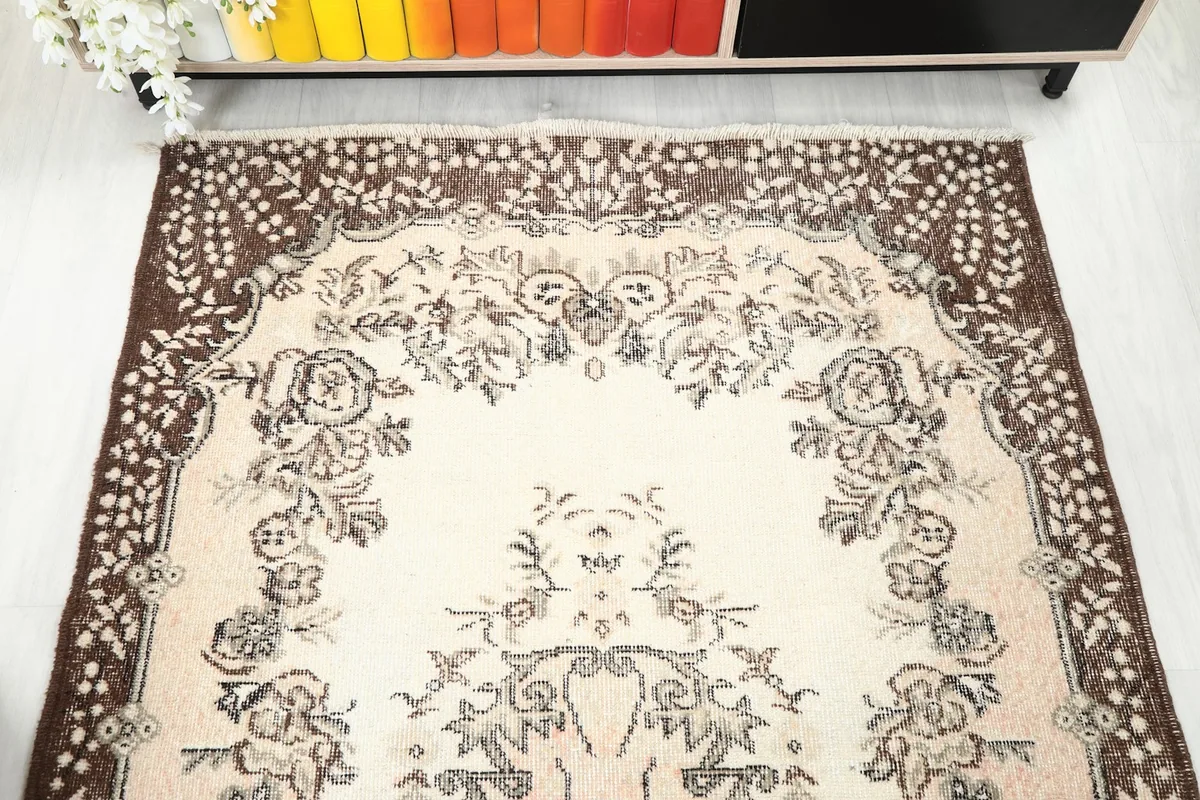 Upper section of the rug showing the floral patterns and border
