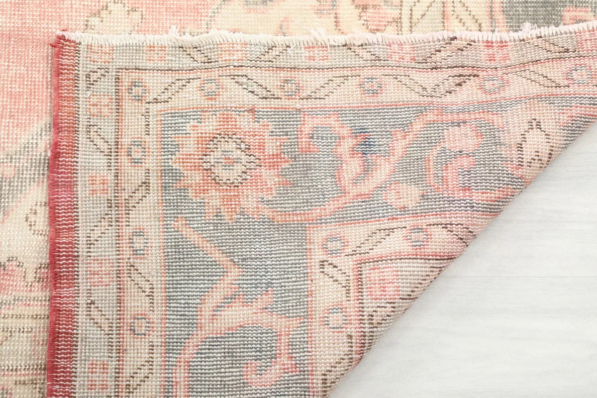 Underside of the rug showing the tight hand-knotted construction and fringe