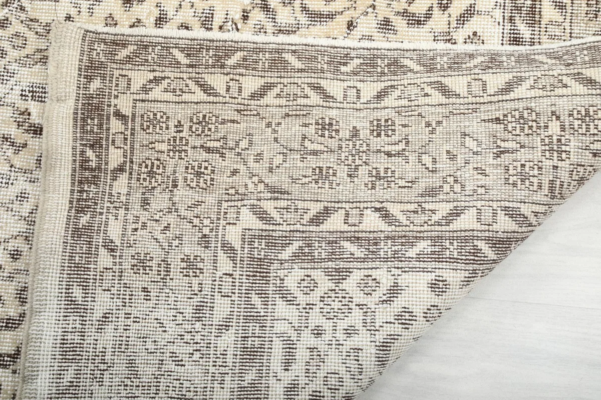 Close-up of the rug's back side and foundation, showcasing the hand-knotted construction.