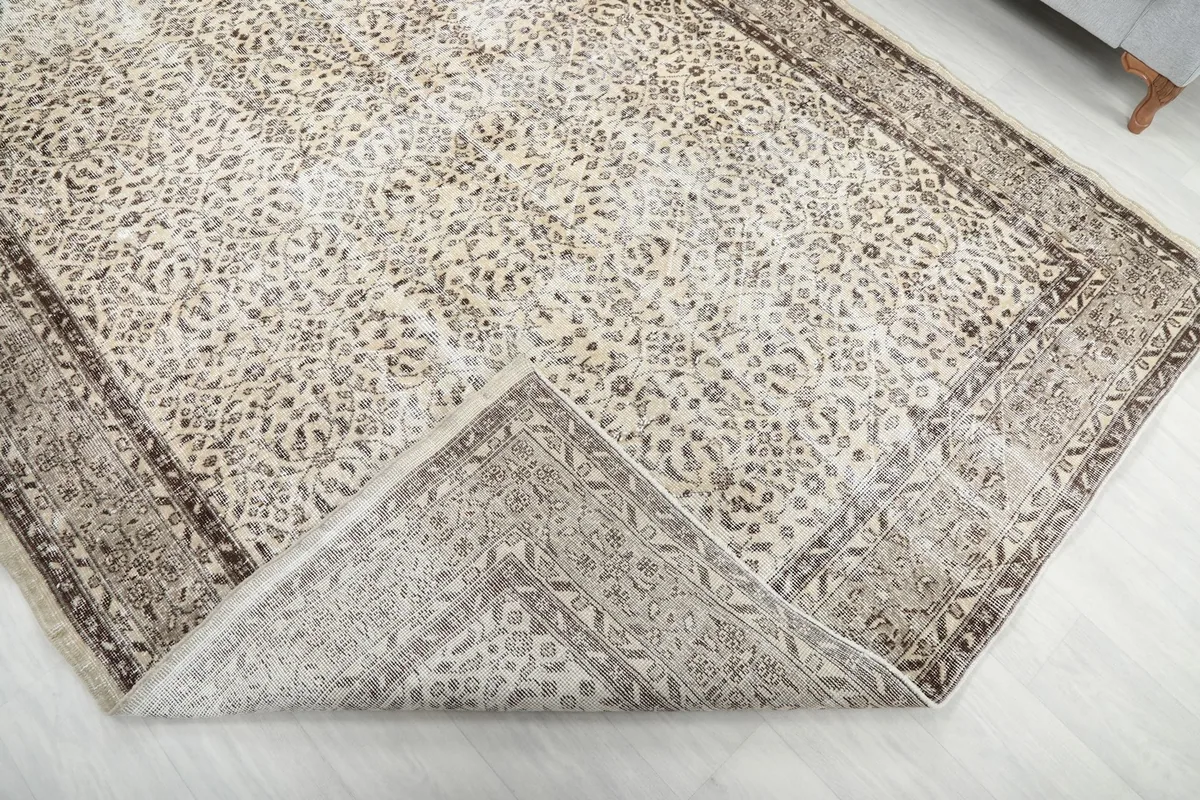 The rug folded back to reveal the cotton foundation and the reverse side of the hand-knotted pile.