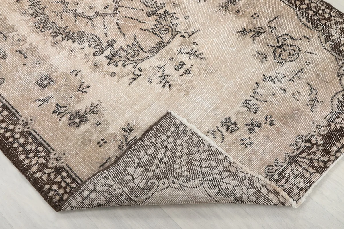 View of the back of the hand-knotted rug, revealing the cotton foundation and knotting