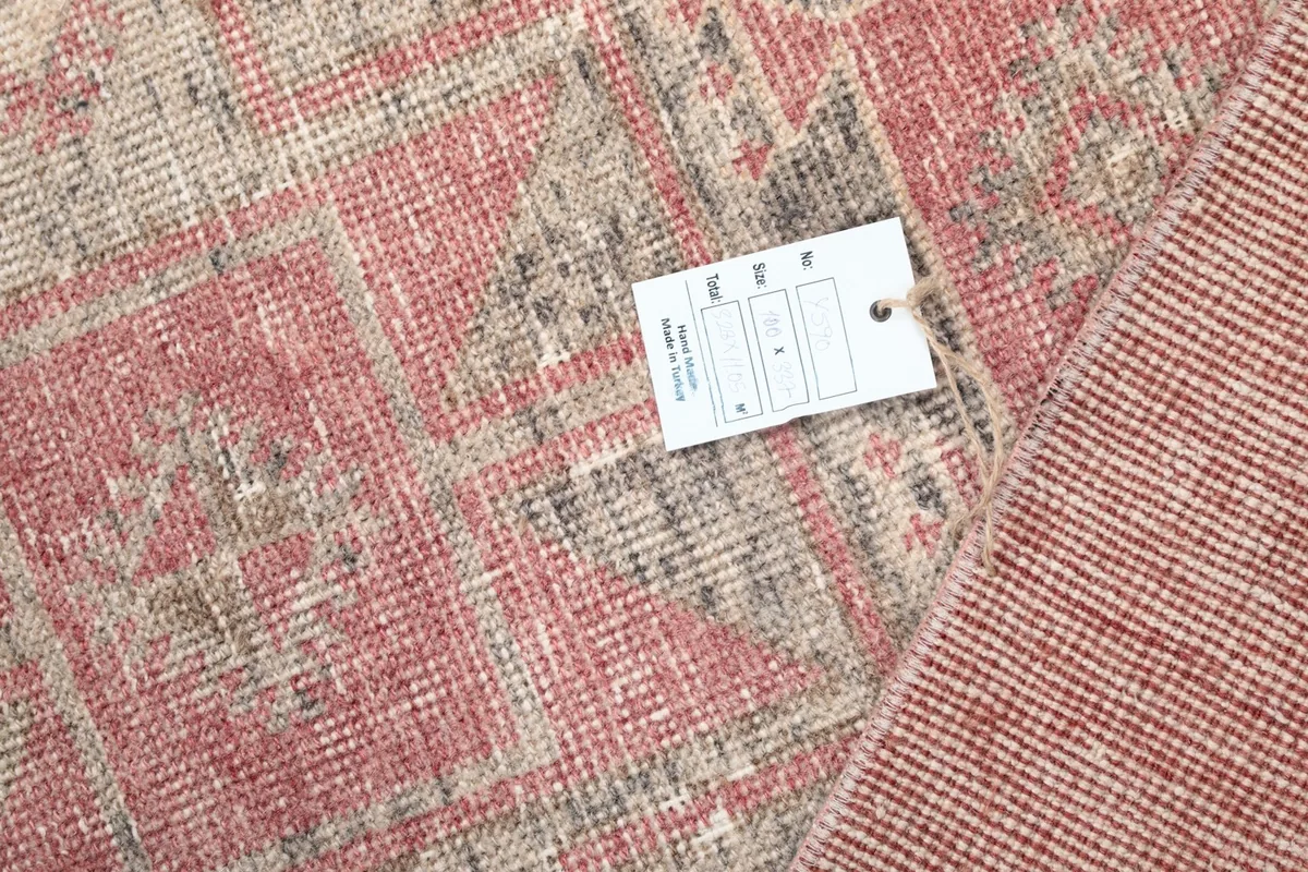 Close-up of the rug's label attached to the back, showing details