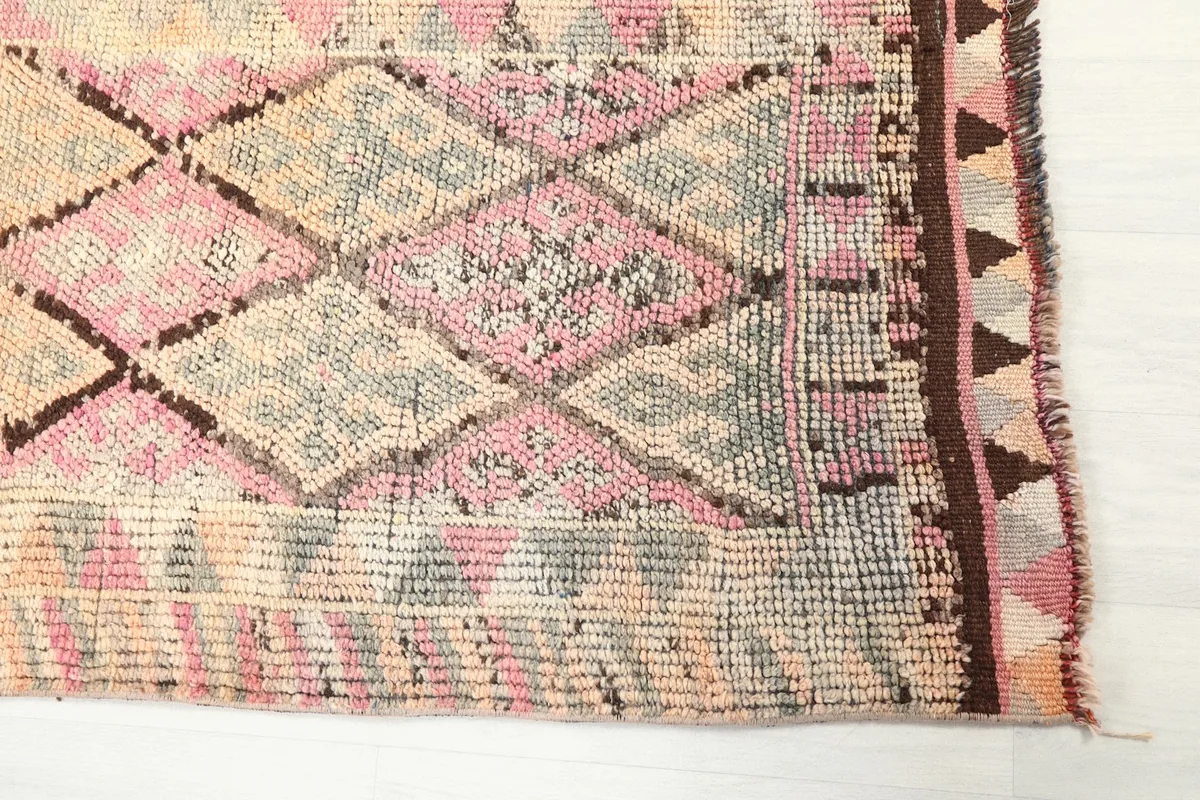 Detailed view of the geometric motifs and border design on the vintage runner