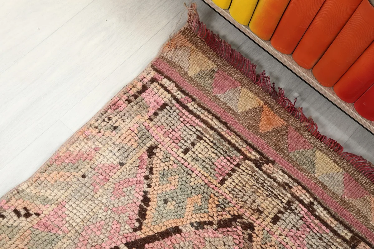 Detail of the end border and fringe, showing tribal patterns and color transitions