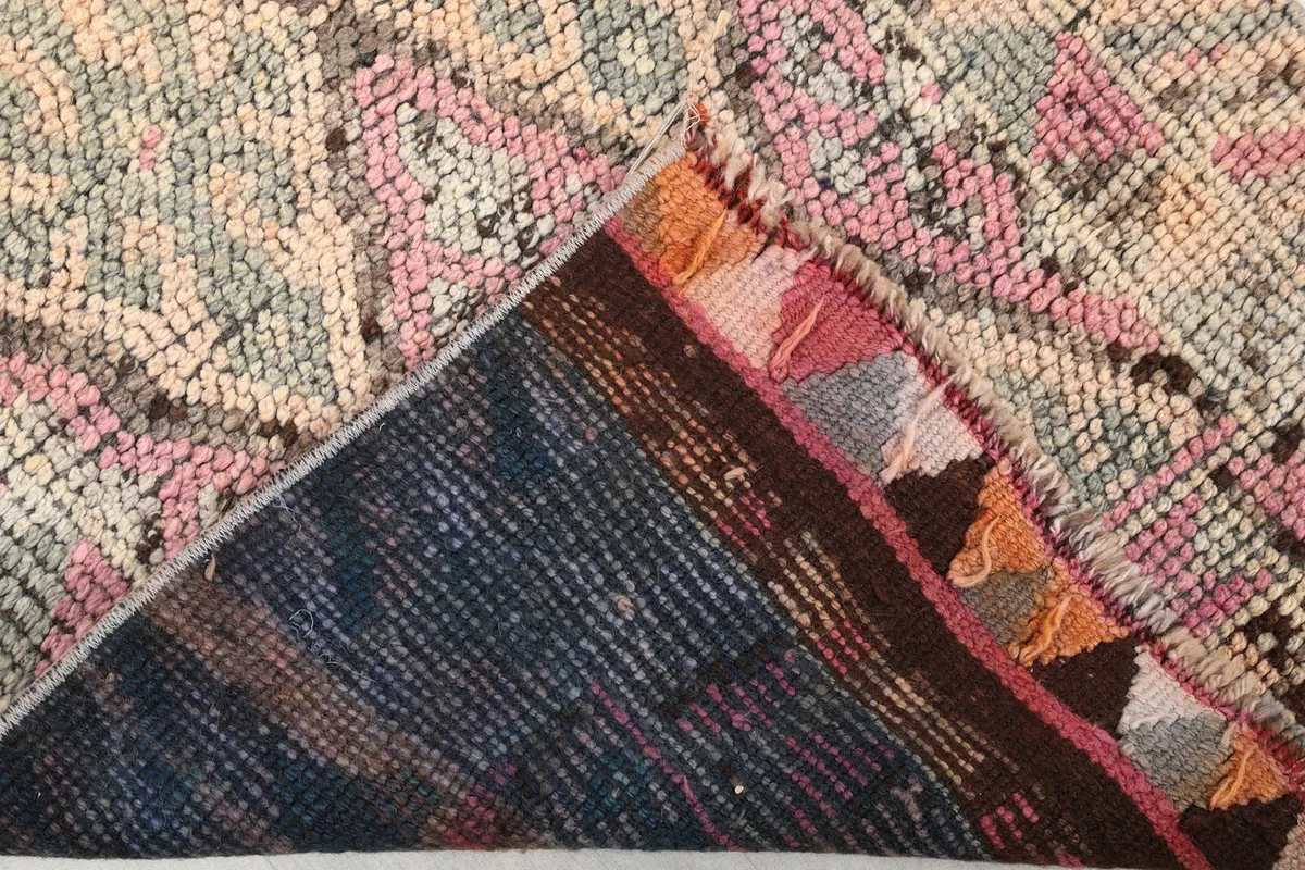 Underside of the hand-knotted rug, revealing the cotton foundation and knotting