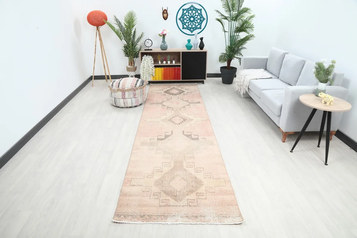 Vintage rose runner rug in a modern hallway setting with sofa and plants