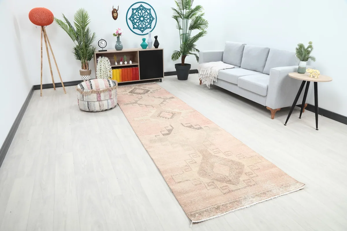 Angle view of the rose runner rug in a room, showing its length and placement