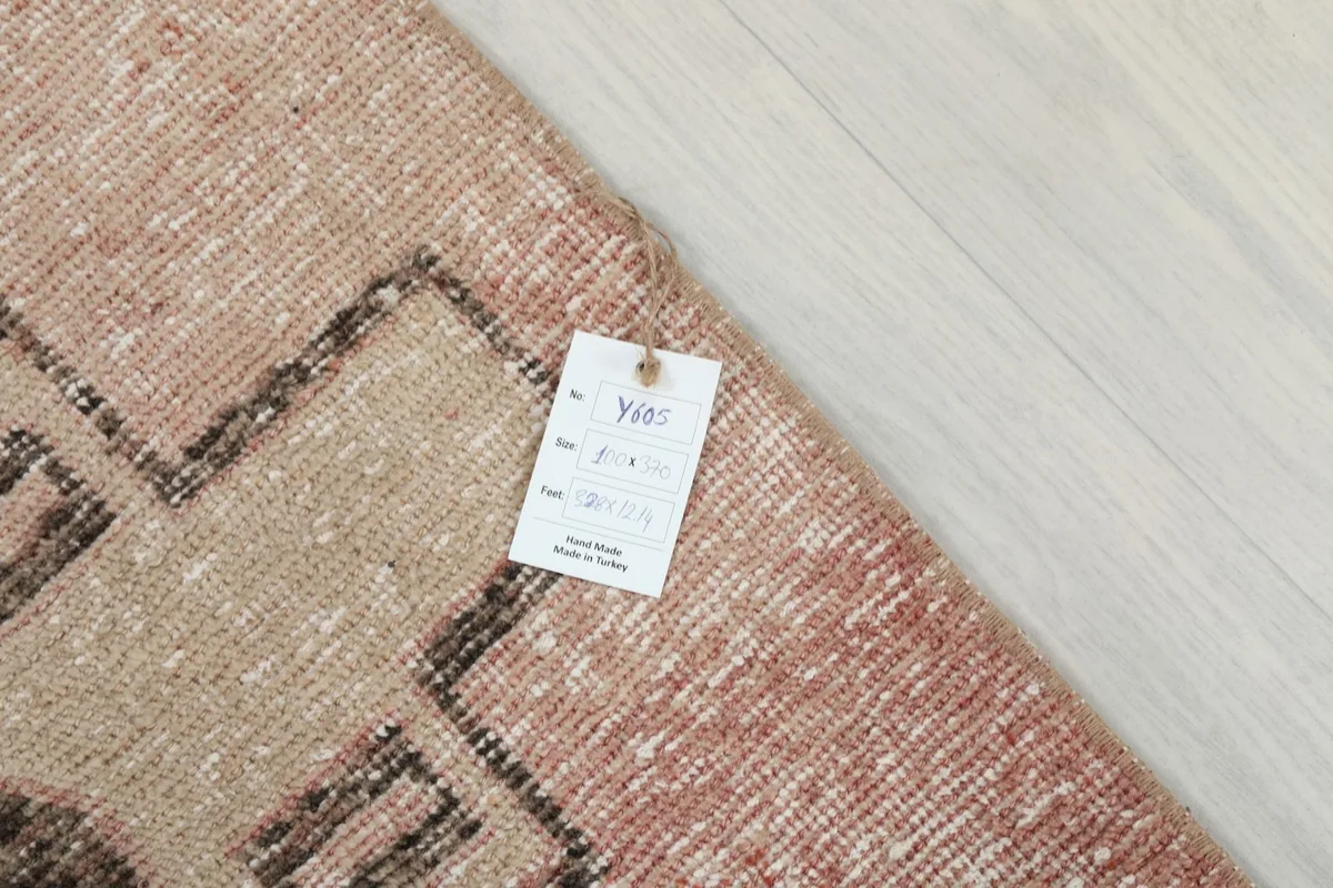 Close-up of the rug's surface with an identification tag showing details