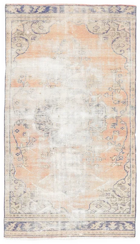 Full top view of the rust and blue vintage Anatolian rug with faded medallion design on a white background.