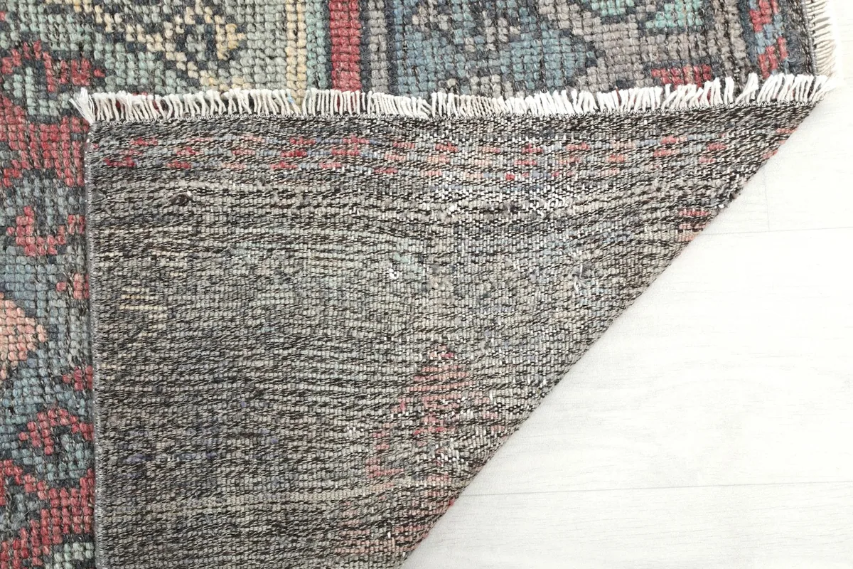 Close-up of the rug's back and fringe, revealing the natural fiber construction
