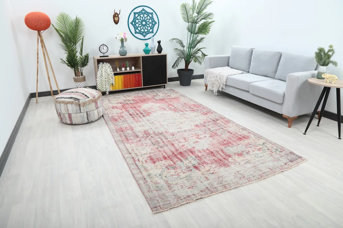 Angle view of the large rose medallion rug in a modern living space, showing its full length.