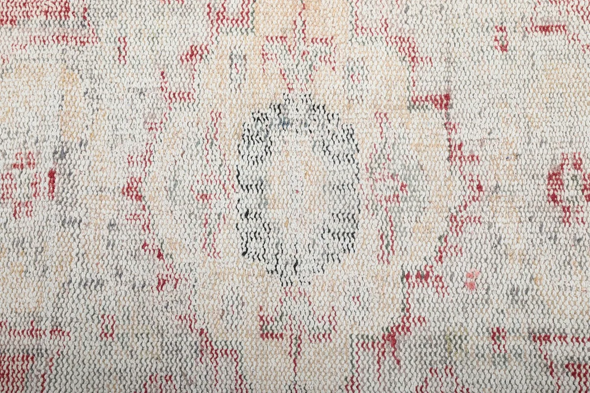 Detailed view of the rug's texture and pattern, showing the low pile and intricate knotting.