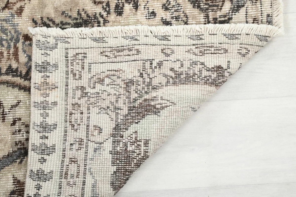Underside view of the rug, showing the hand-knotted construction and fringe