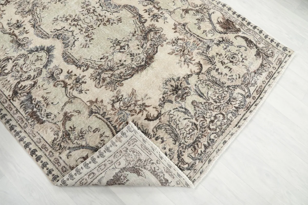 Folded corner of the rug, revealing the wool pile and cotton foundation