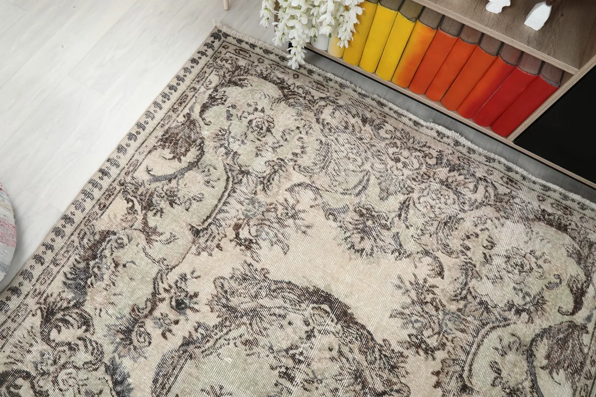 Overhead view showing the rug's placement near a bookshelf with colorful books