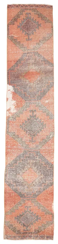 Full overhead view of the rust and gray geometric Anatolian runner on a white background