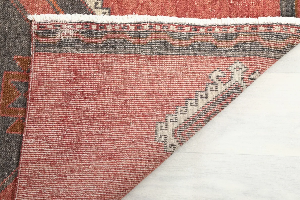 Underside view of the hand-knotted cotton foundation and rug edges