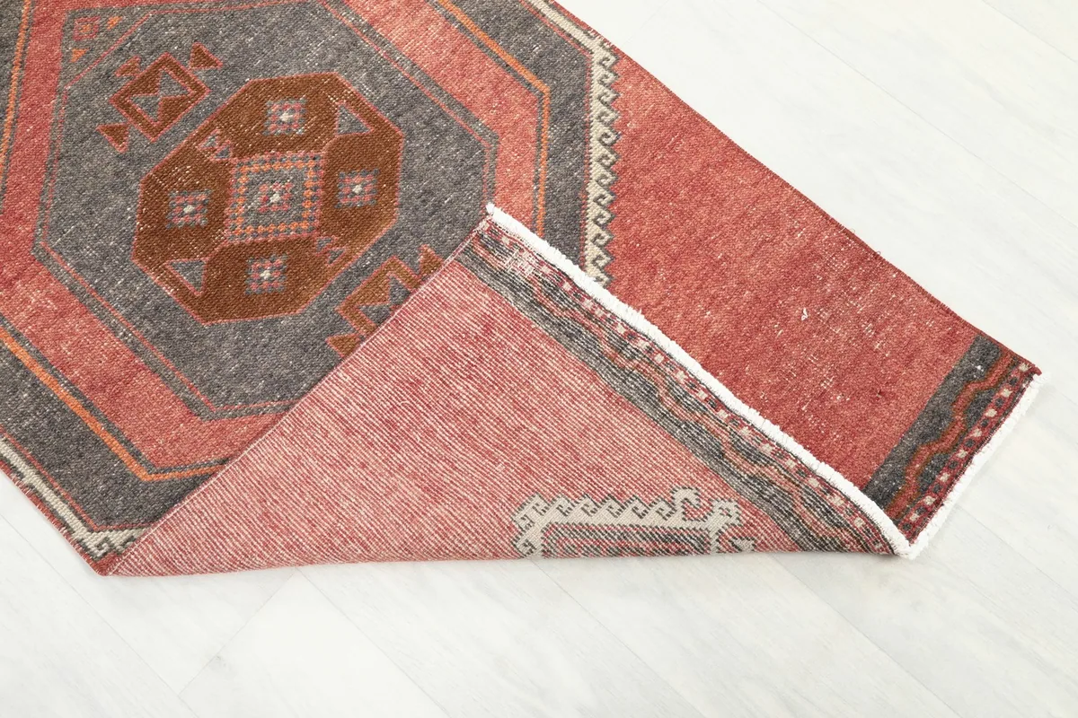 View of the rug folded to show the wool pile on cotton foundation