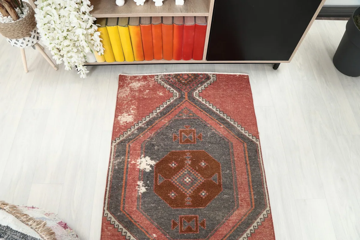 Overhead view showing the rug's pattern and distressed areas from above