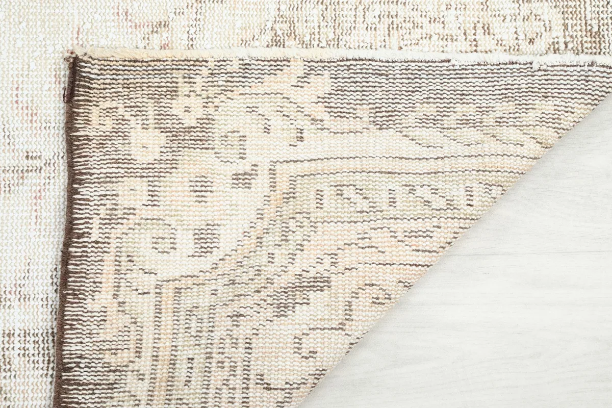 Close-up of the rug's reverse side, showing the intricate knotting and foundation