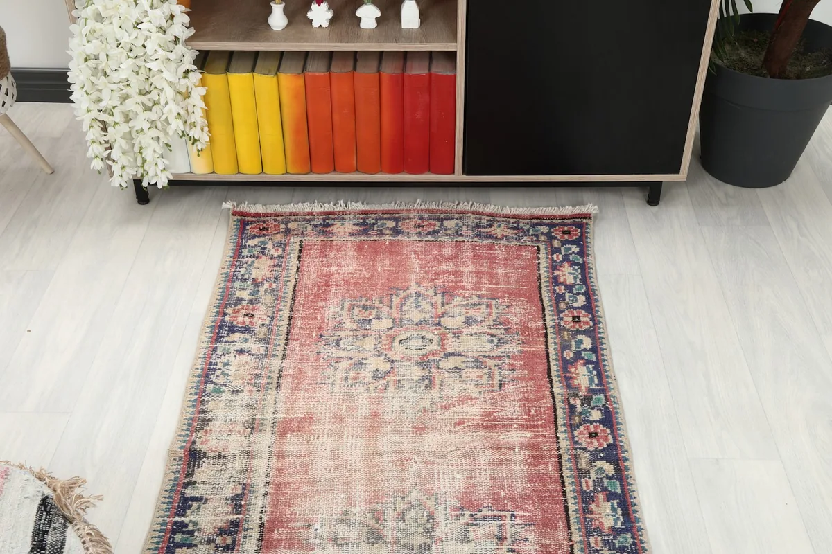 Overhead view of the runner rug in a room setting, showing its placement in front of shelving.