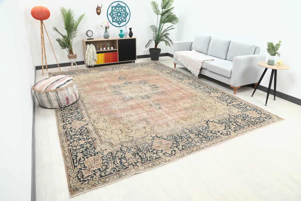 Faded Rose Navy Medallion Floral Rug in a room, offering a different angle to appreciate its overall design.