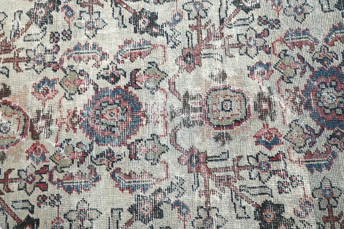 Detail of the Cream Rose Floral Anatolian Rug's pile, showing individual knots and faded areas