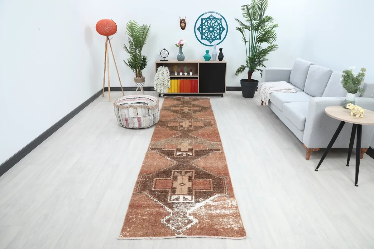 Vintage Anatolian runner rug displayed in a modern living room setting, showcasing its length and pattern.