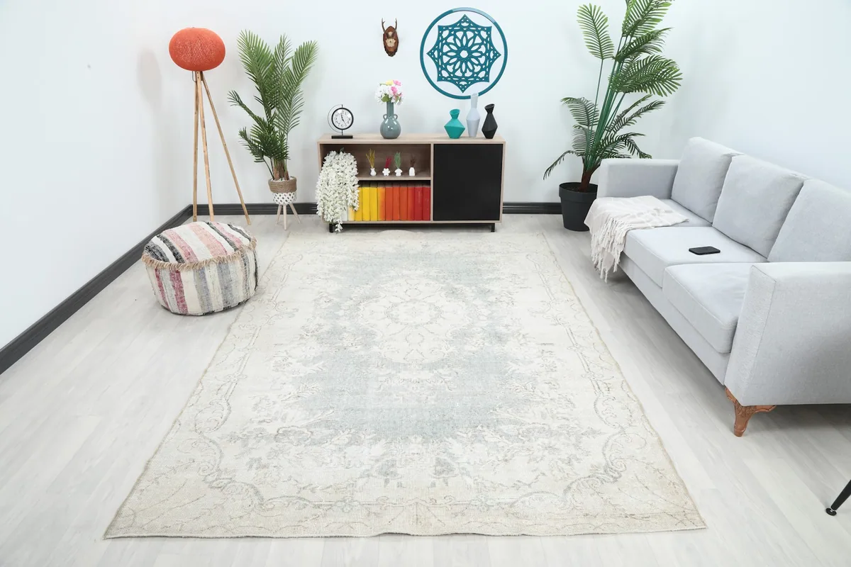 Vintage Anatolian rug in a living room setting with a light grey sofa