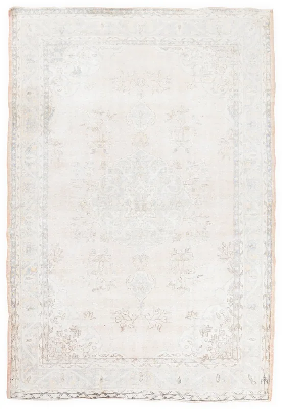 Full top view of the beige vintage Anatolian area rug with faded floral medallion motifs.