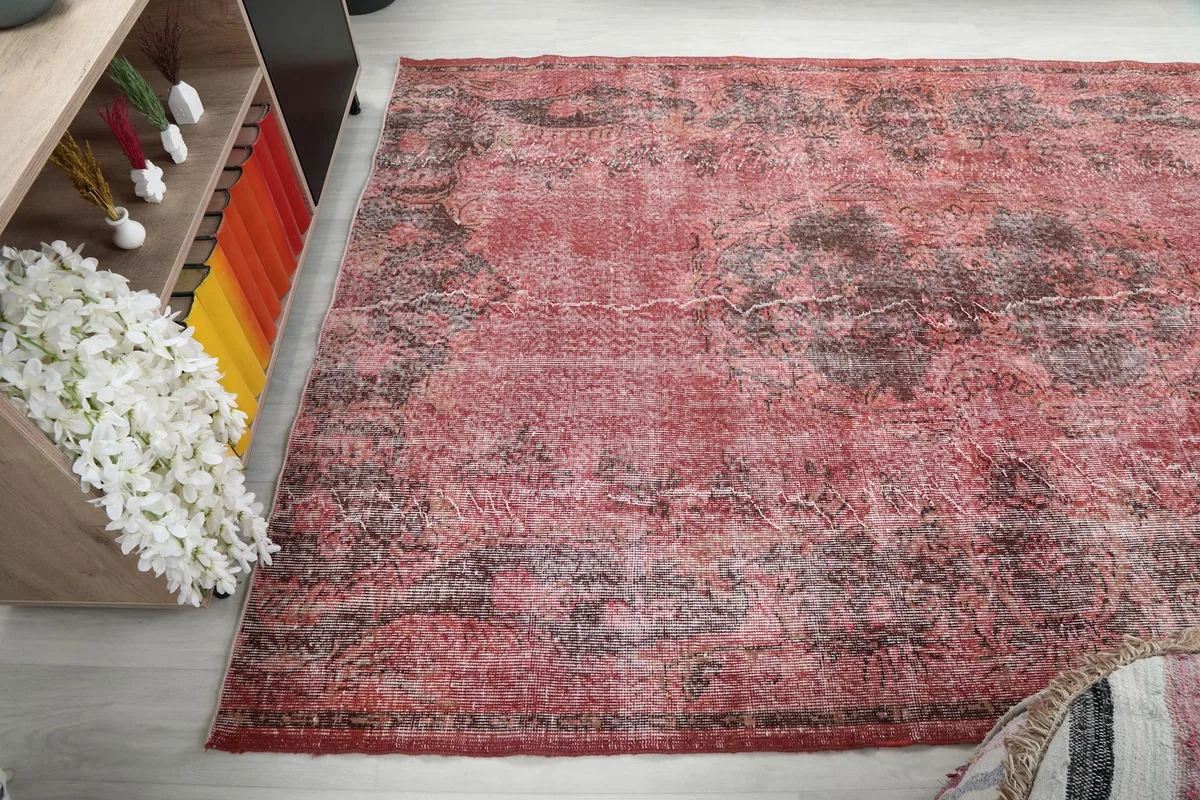 Angled view highlighting the distressed rose and charcoal motifs