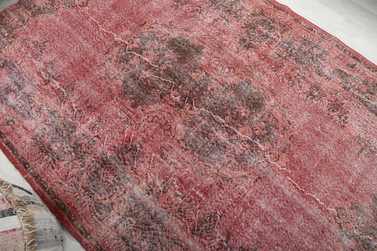 Close view of the distressed pile and central medallion area
